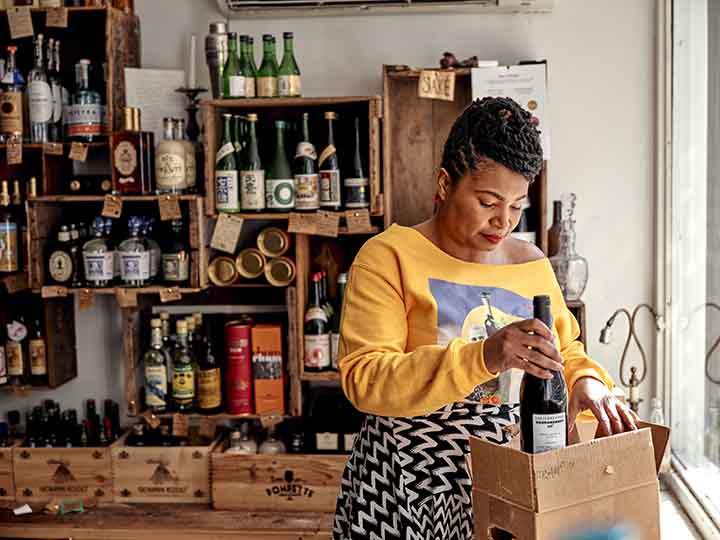 Angela McCrae putting a wine bottle into a box