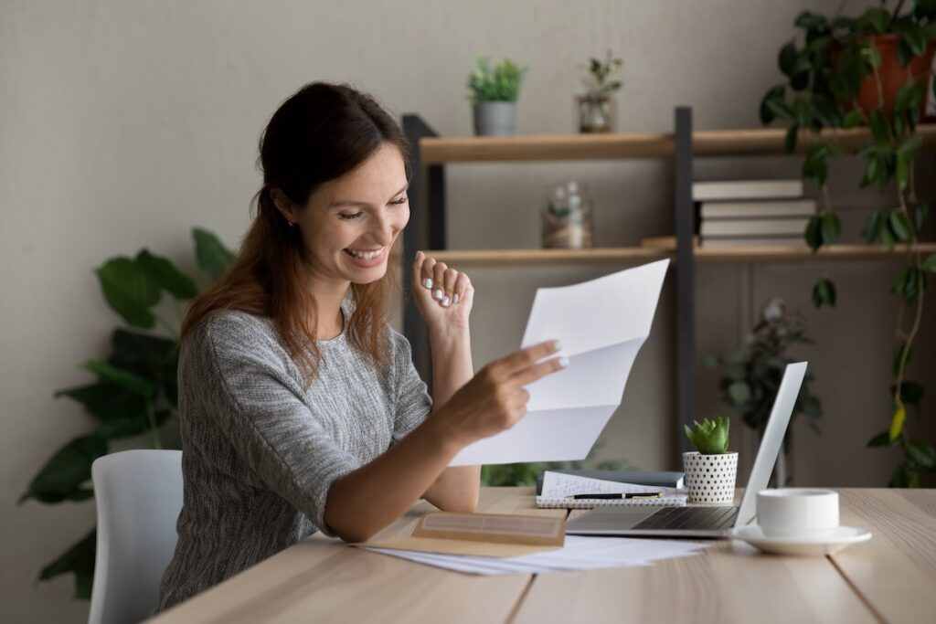 Business owner sits at her desk reviewing accounts receivable and getting paid faster