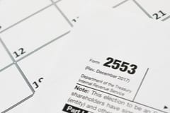 Form 2553 Tax Form laying on top of a monthly calendar.