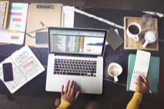 Accounting vs. Bookkeeping - a small business owner looks at a spreadsheet