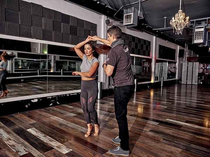 Michael Cahn teaches a student to Salsa dance