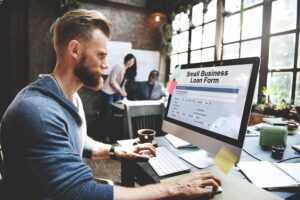man filling out a form for a small business loan