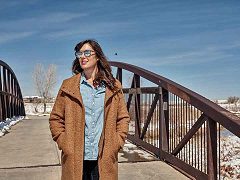 Sarah Murray walking across a bridge
