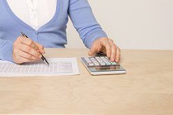A person bookkeeping using a general ledger.