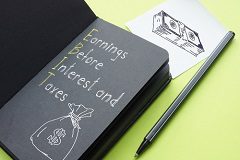 A black notebook opened to a page that says, "Earnings Before Interest and Taxes (EBIT)" 